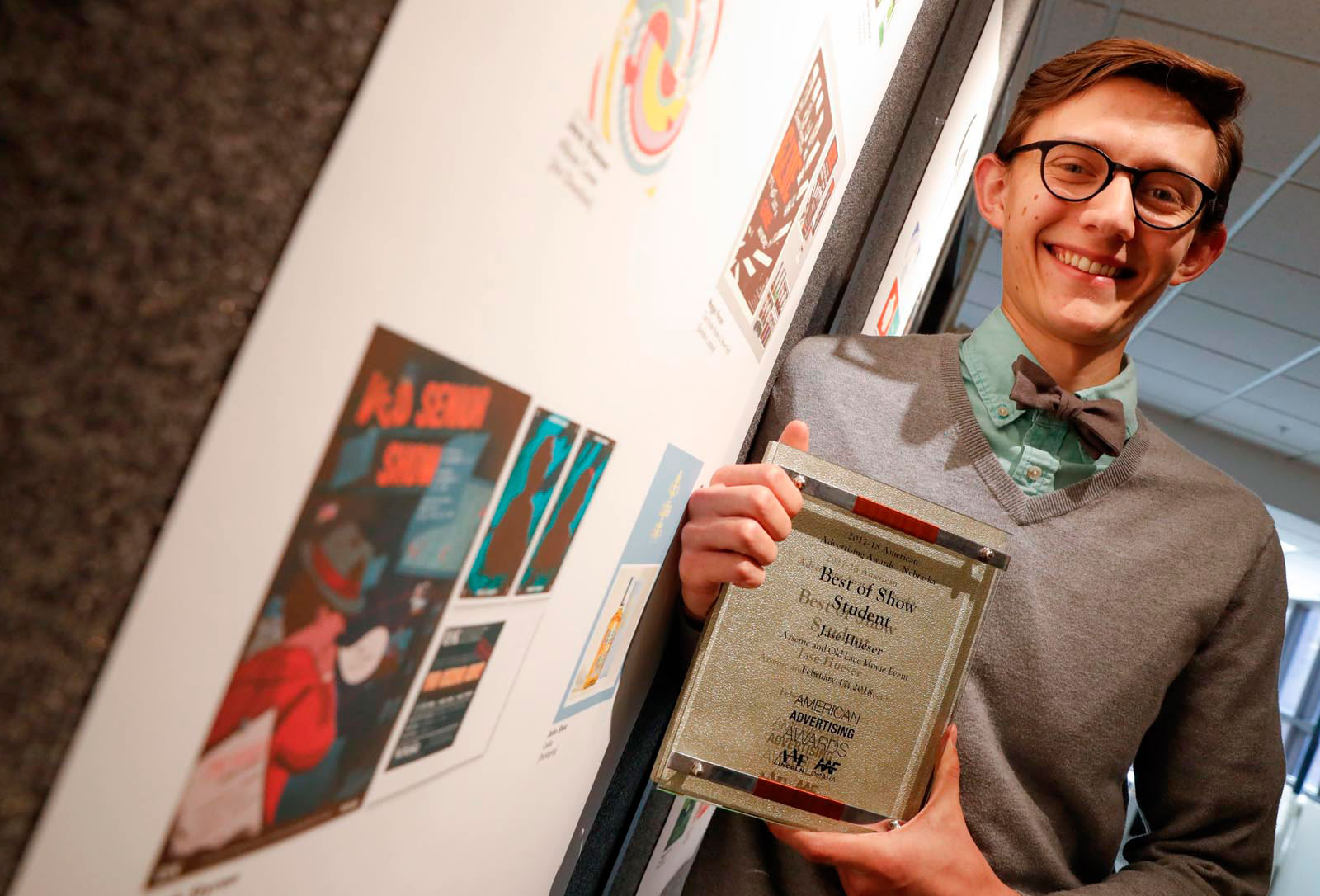 Jase Hueser proudly holding ADDY award