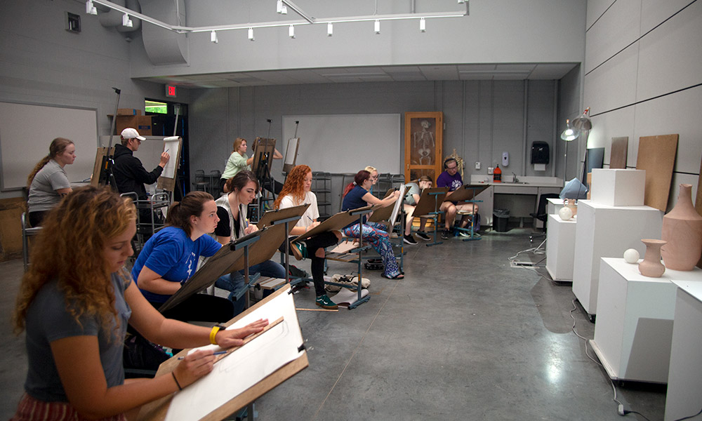 students drawing a still life