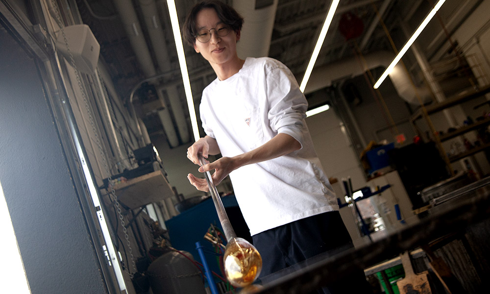 Student working in glass hot shop