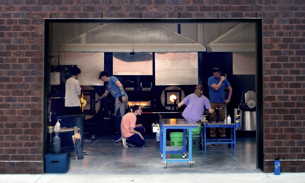 Students working in glass hot shop