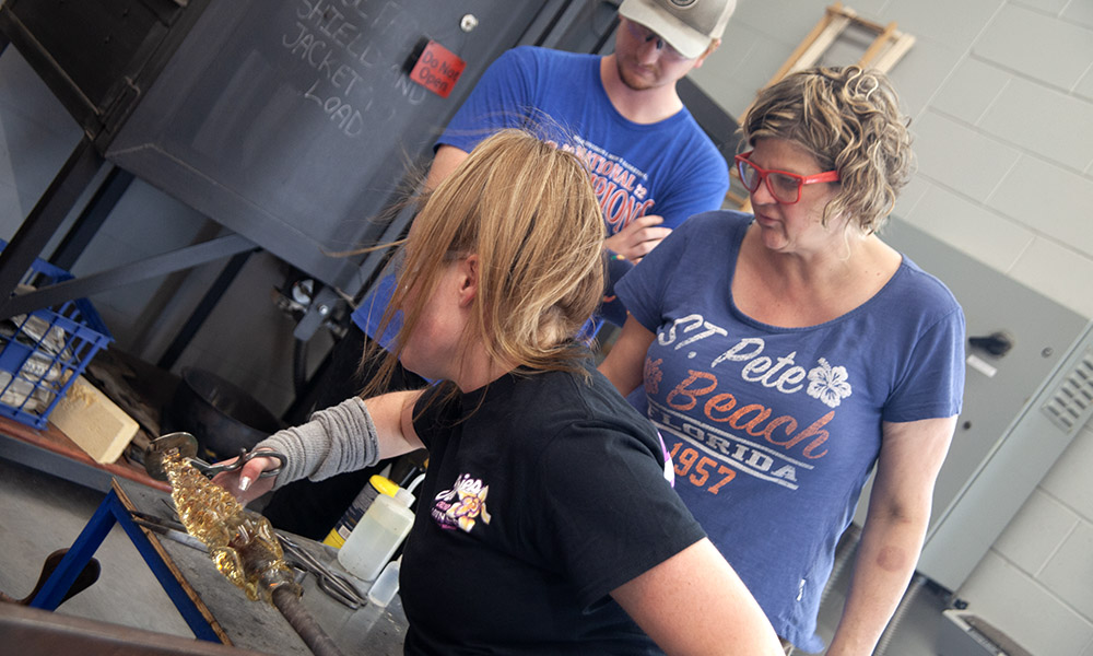 Student working with Professor Saylor in hot shop