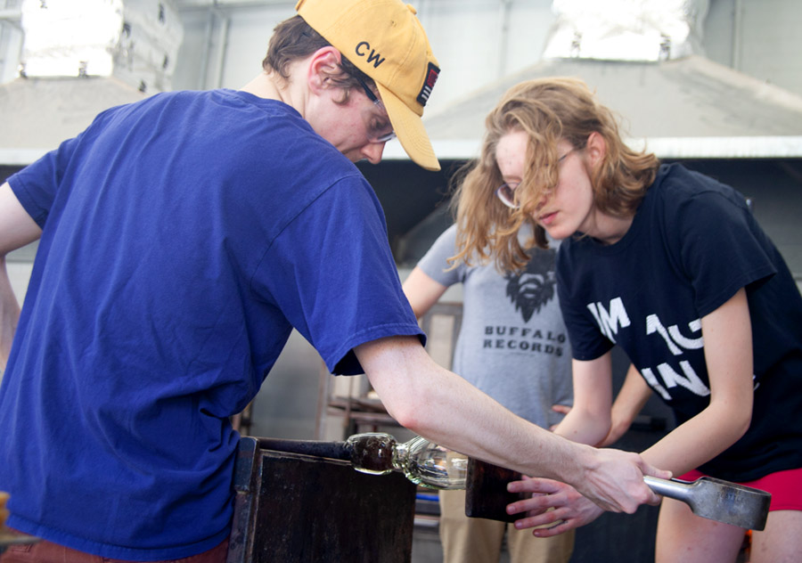 Students working in the glass hot shop